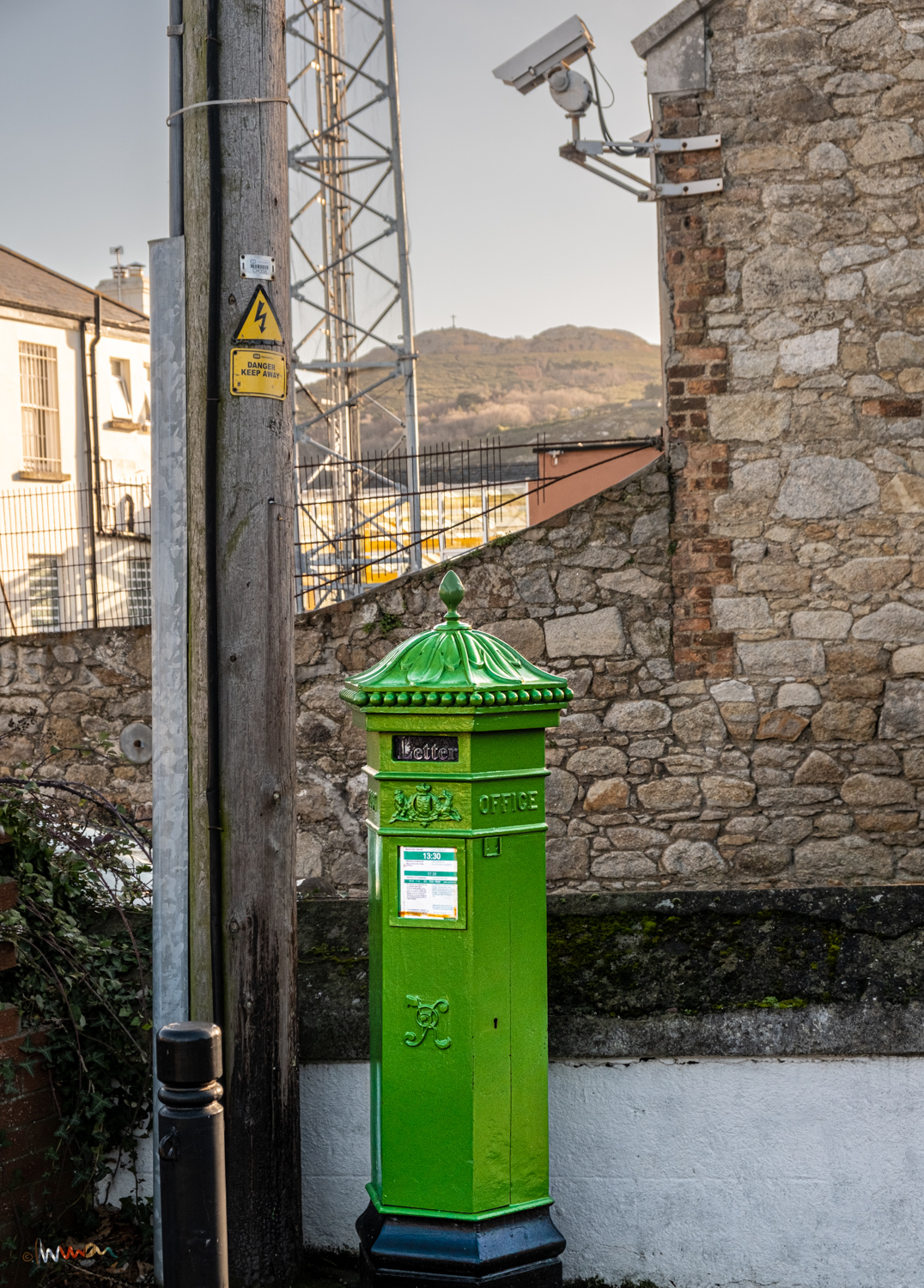 One of three active Penfold post boxes that remain in Ireland. Designed by J W Penfold, they were manufactured and deployed from 1866 to 1879. The Christian cross on Bray Head, a radio mast and CCTV on a police station, a warning of death on a pole, the Queen Victoria imprimatur on a postbox replaced by less troublesome cylindrical designs. Change.
